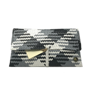Handmade black, grey and white clutch facing the front.