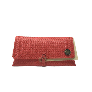 Handmade coral red wristlet facing the front.